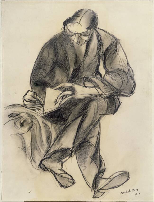 Figure assise lisant Laszlo Moholy-Nagy