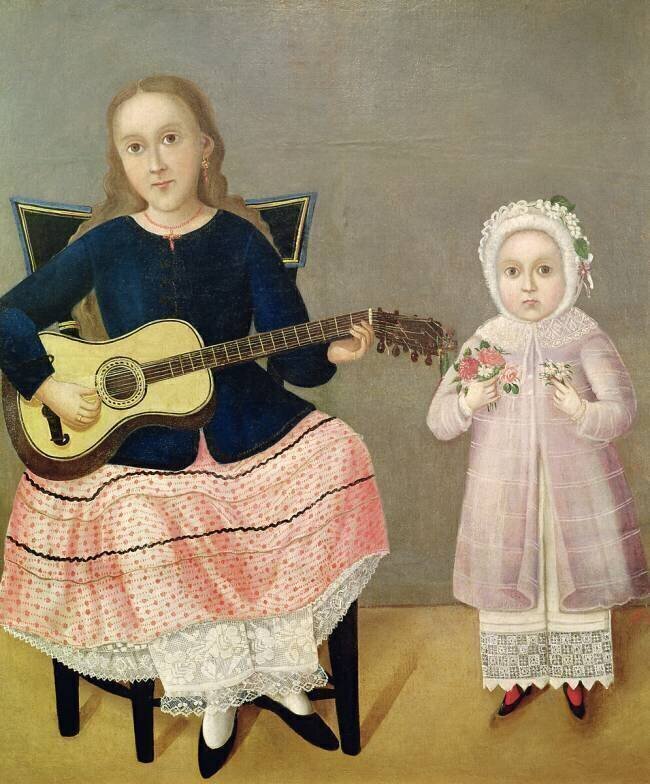 Jeune fille avec une guitare et enfant avec un bouquet anonyme