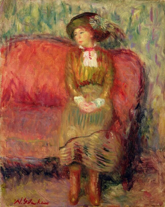 Fille assise sur un canapé rouge William James Glackens