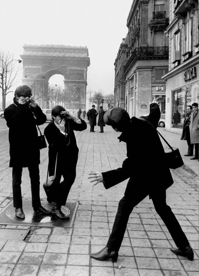 The Beatles in Paris : John Lennon Photographed By George Harrison and Paul McCartney on Champs Elysees in Paris January 15, 1964 (b/w photo) Rue des Archives