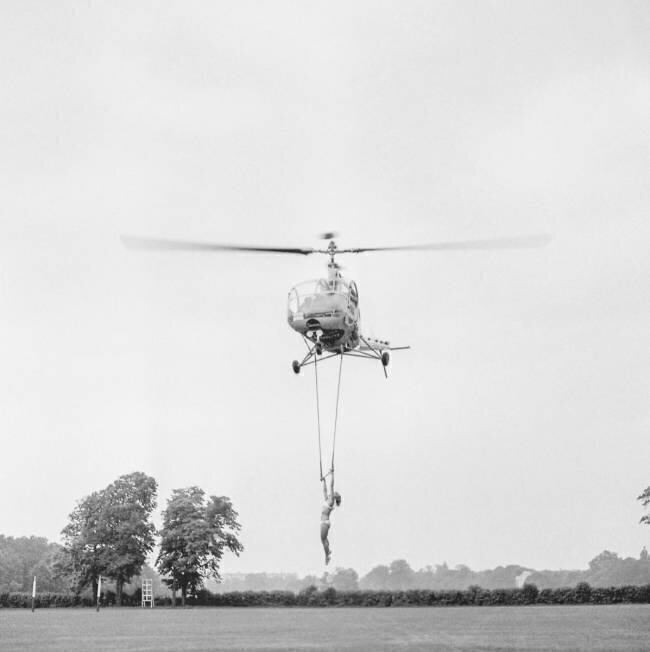 The trapeze artist Andree Jean during a demonstration with an helicopter at the Polo de Bagatelle, Paris, June 16, 1951 (b/w photo) Rue des Archives