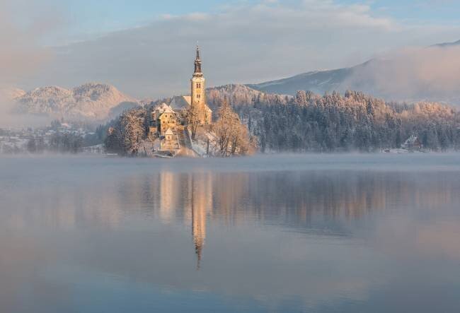 Lake Bled with the church and the castle on a calm winter morning Ales Krivec