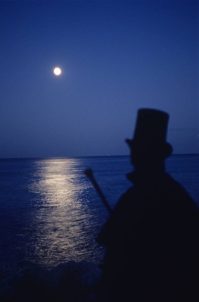 Man in top hat starring at the moon Philippe Abergel