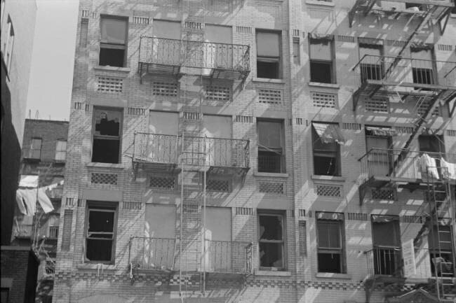 New York, New York. 61st Street between 1st and 3rd Avenues. House fronts Walker Evans