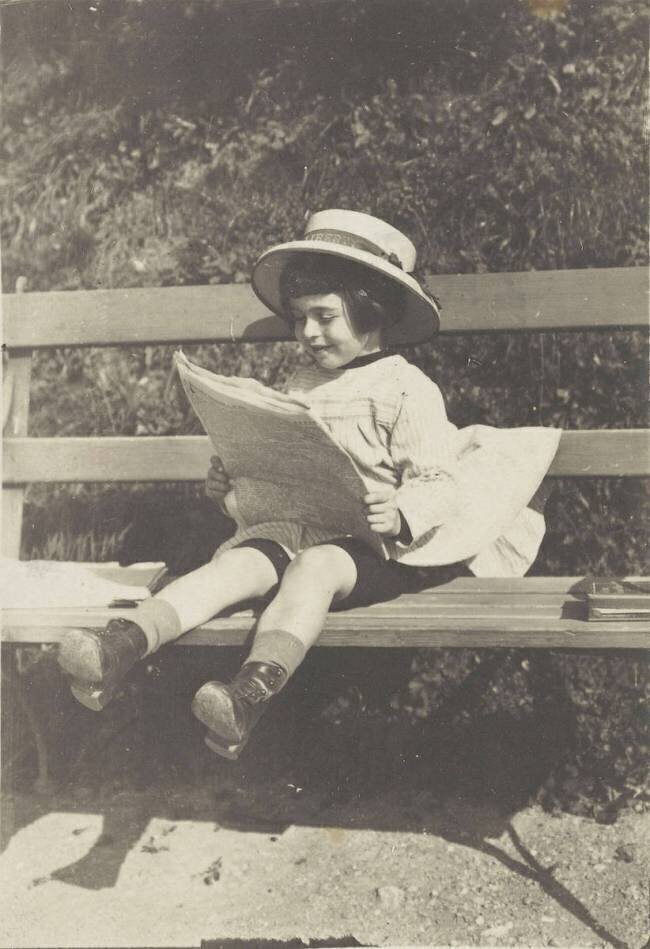 Jeune enfant lisant sur un banc anonymous