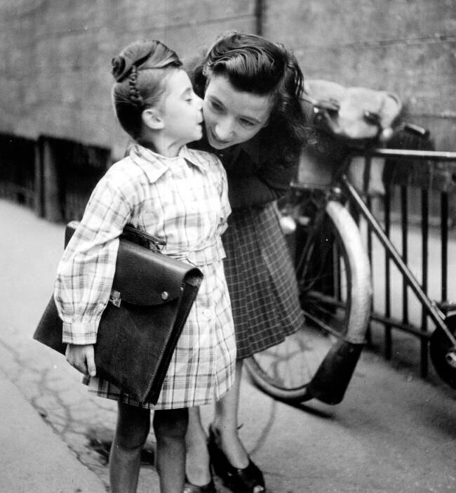 Little Girl Kissing her Mother Start of School Year in France  Rue des Archives
