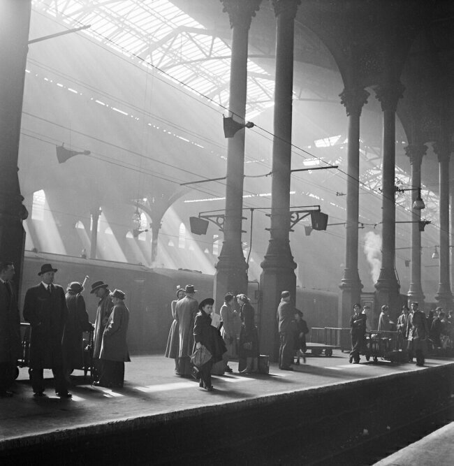 Passengers waiting for a train on a platform at Liverpool Street Station  John Gay