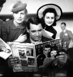 Cary Grant in Paris in 1946 Reading Swedish Magazine (Rue des Archives) - Muzeo.com