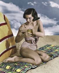 Jeune femme en bikini utlisant de la creme solaire sur une plage (anonyme) - Muzeo.com