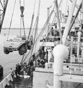 A giant truck Berliet T 100 is loaded in Le Havre on the cargo 