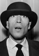 French Actor Philippe Clay Trying on Bowler Hat in A Shop in Paris (Rue des Archives) - Muzeo.com