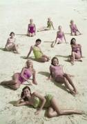 High angle view of a group of young women sunbathing on the beach (anonymous) - Muzeo.com
