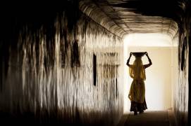 Woman in a corridor of Amber Fortress, Jaipur India (Patrick Hochner) - Muzeo.com