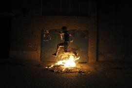Boy jumping over a bonfire, Tehran, Iran (Fred Dufour) - Muzeo.com