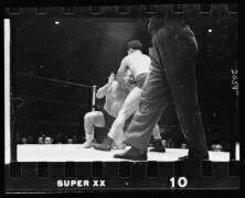 A wrestler holding Gorgeous George by the chin and back of the head, executing a maneuver during a wrestling match (Stanley Kubrick) - Muzeo.com